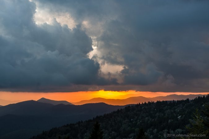 "Reappearing Sun over Cowee Mountains" by John MacLean Photography